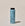 A bottle of ACURE dry shampoo on a neutral background.